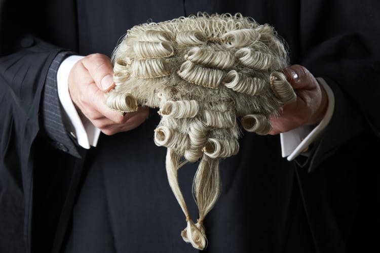 barrister holds a wig, illustrates the successful QC appointments