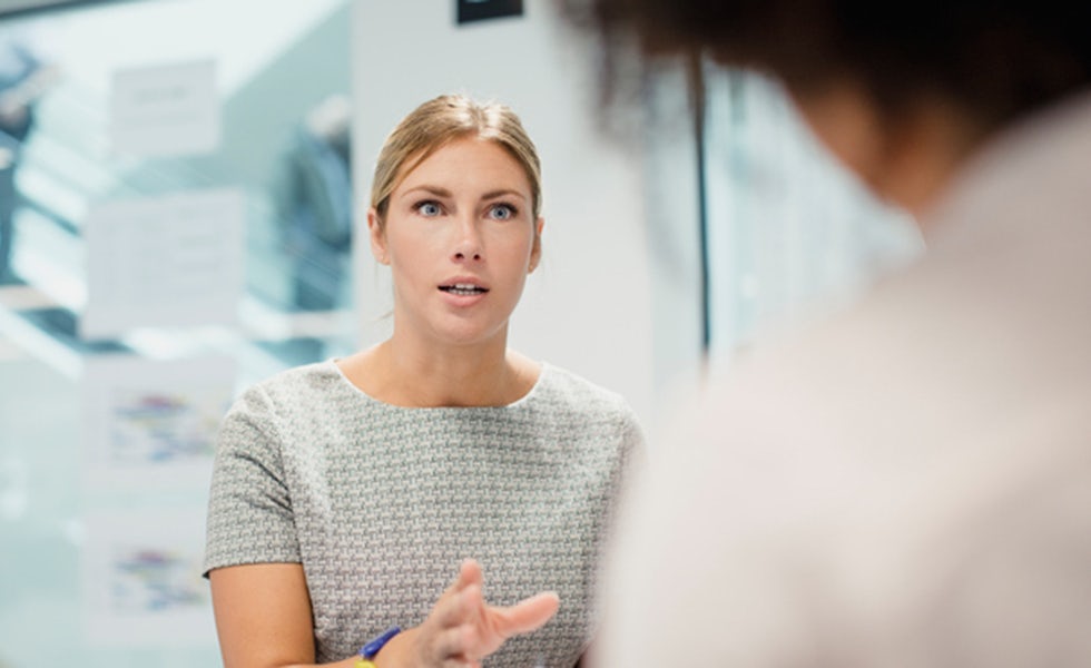 woman taking control in a meeting, to illustrate how to ask for pay rise