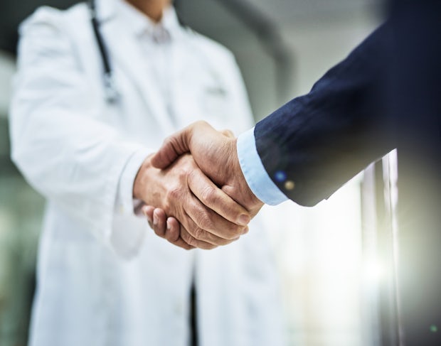 Healthcare investment opportunities: doctor shaking hands with a businessman