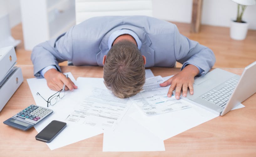 Businessman being depressed by accounting in his office