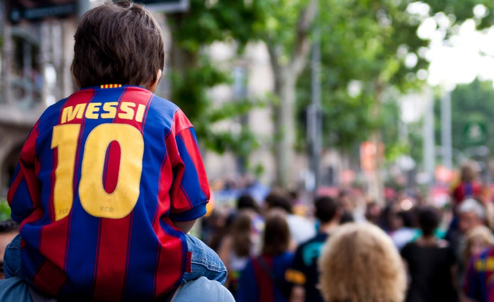 Barcelona, Spain - May 29, 2011. Kid celebrates the victory of the Champions League of his team in catalunya square.