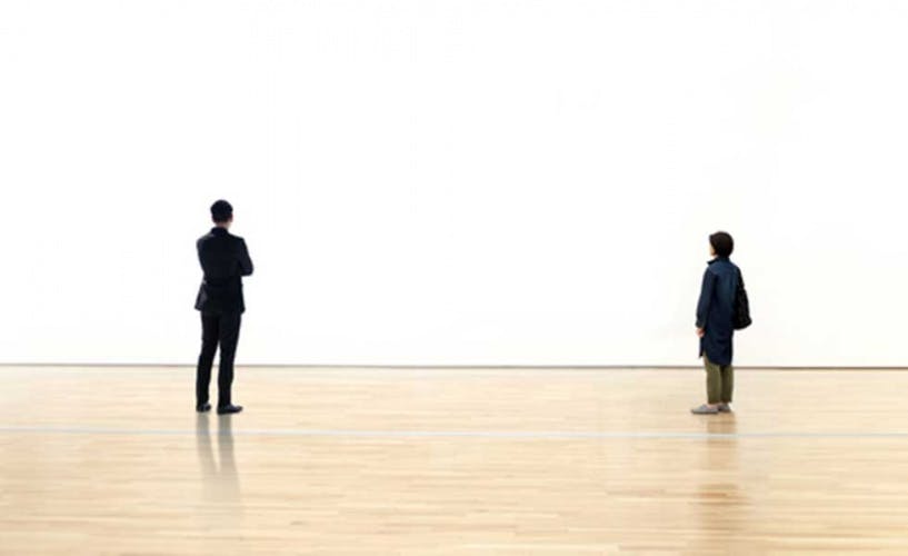 Man and Woman watching blank space wall in modern gallery, Art exhibition minimal concept, Social distancing with copy space concept, Coronavirus or Covid-19 Contagious disease concept